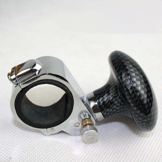 Steering wheel spinner knob with carbon fiber finish on white background, quality car accessory for sps street style.