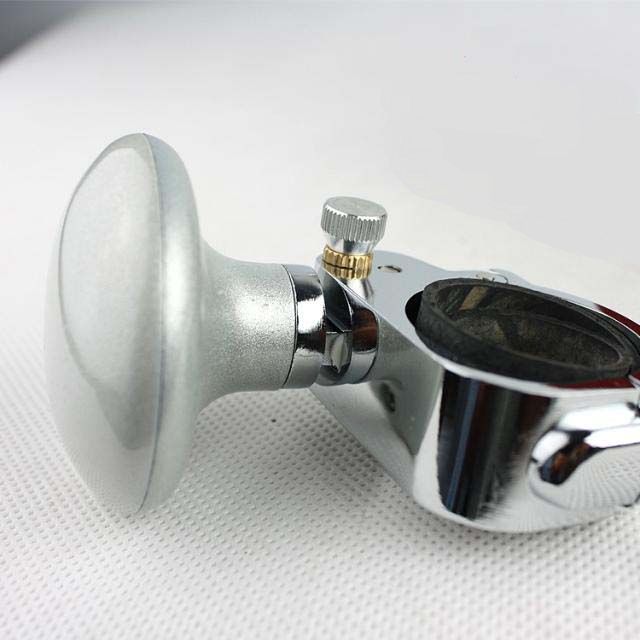 Silver universal steering wheel knob, ergonomic grip, chrome finish, on white background