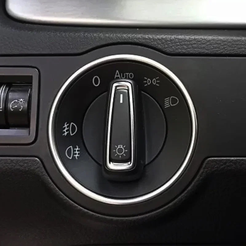 Close-up of a car headlight control switch with black and silver design, sps street style
