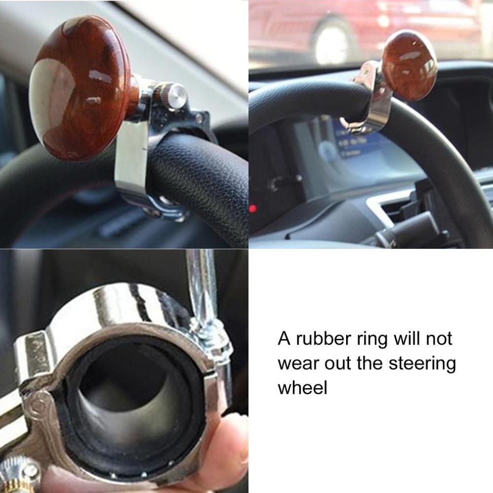 Car steering wheel spinner knob with wood finish and metal clamp, quality driving accessory.