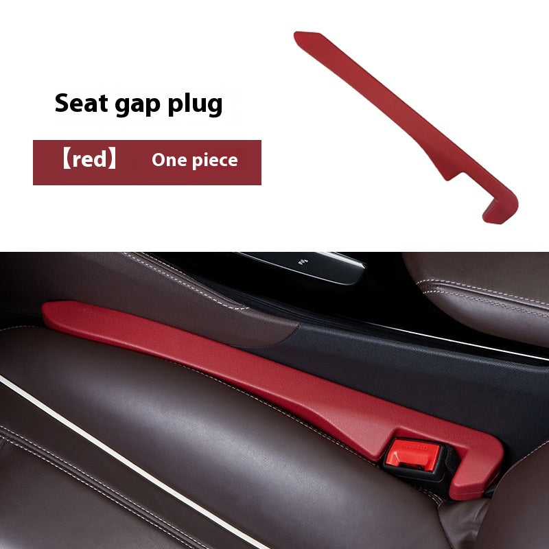 Red seat gap plug for cars, useful car accessory shown between brown leather seats