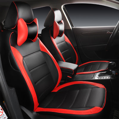Black and red leather car seat covers with matching headrest pillows in a modern sedan
