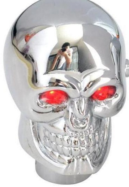 Chrome skull with red LED eyes, reflective surface, quirky street style decor