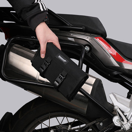 Person placing black tool pouch on motorcycle, sps street style quality gifts