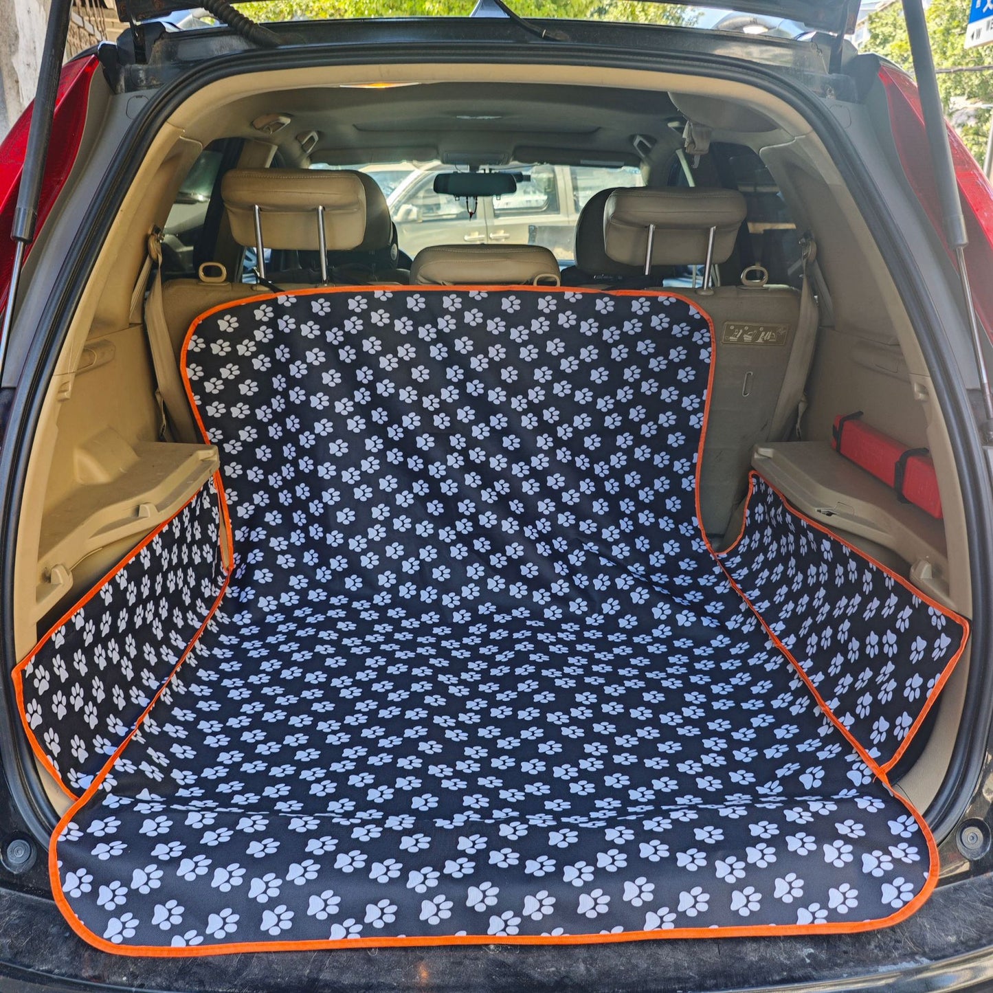 SUV trunk with black paw print pet cargo liner, ideal for quality gifts and useful items