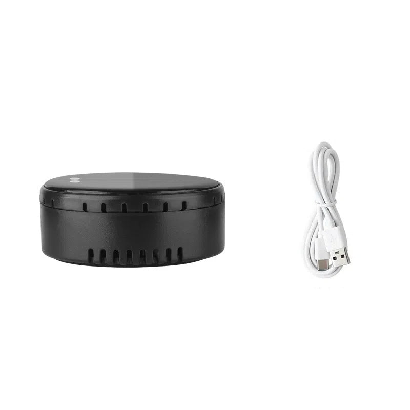 Black round electronic device with USB charging cable, sps street style quality gift
