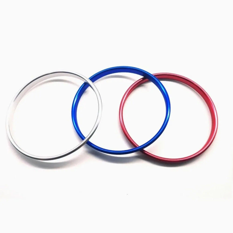 Three metal rings in silver, blue, and red on a white background, street style gift item