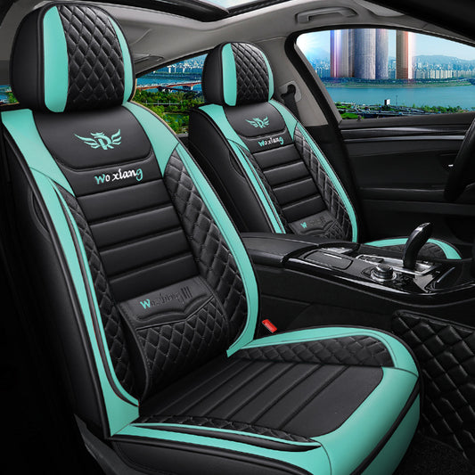 Black and teal diamond-stitched car seat covers in modern car interior, city view outside window