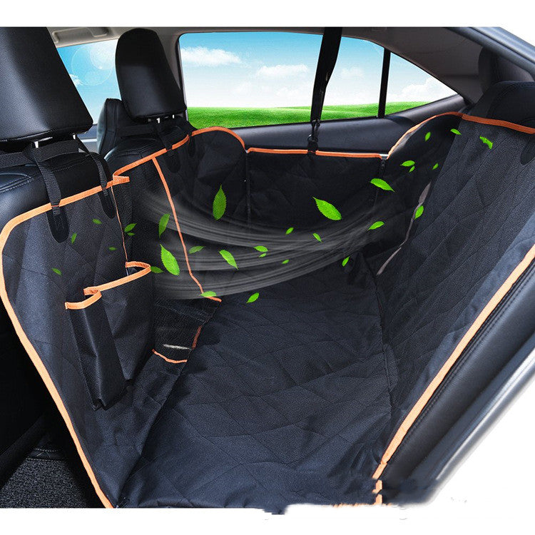 Quilted black car back seat cover with orange trim, pockets, and mesh barrier, ideal for pet travel