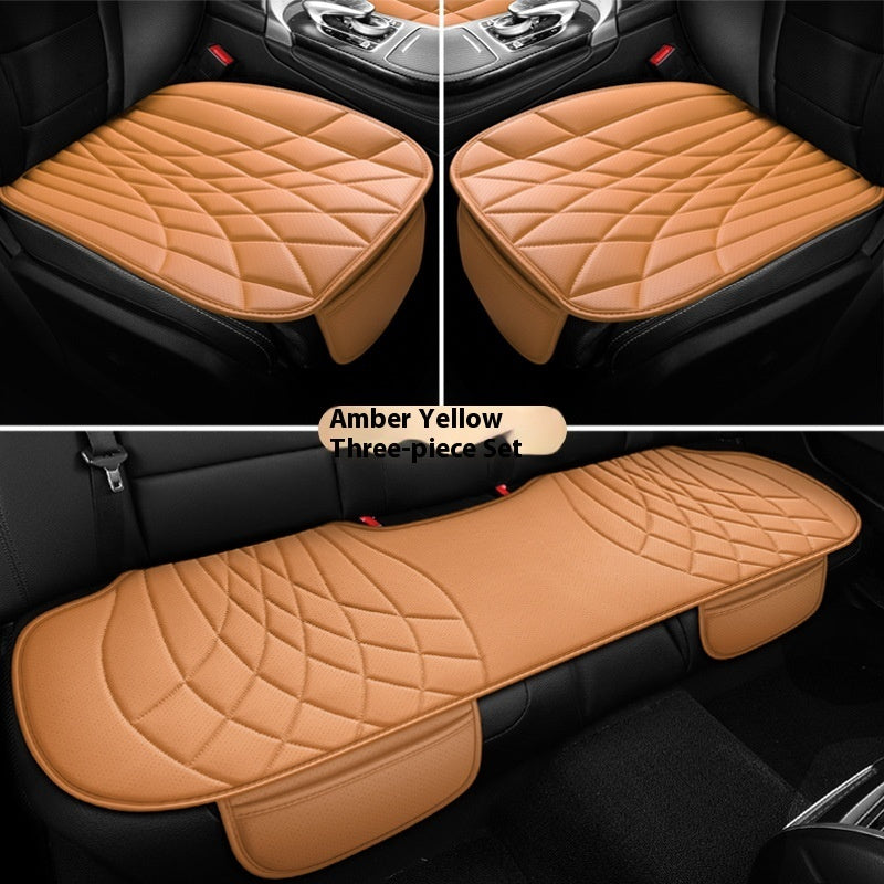 Amber yellow three-piece car seat cover set, quilted design, shown on black car seats.